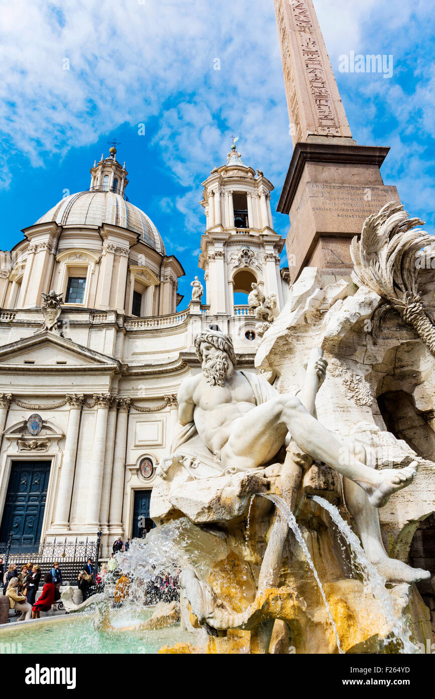 Rome, Italy.  Piazza Navona. Fontana dei Quattro Fiumi, or Fountain of the Four Rivers, created by Gian Lorenzo Bernini. Church of Sant'Agnese in Agone behind. Stock Photo