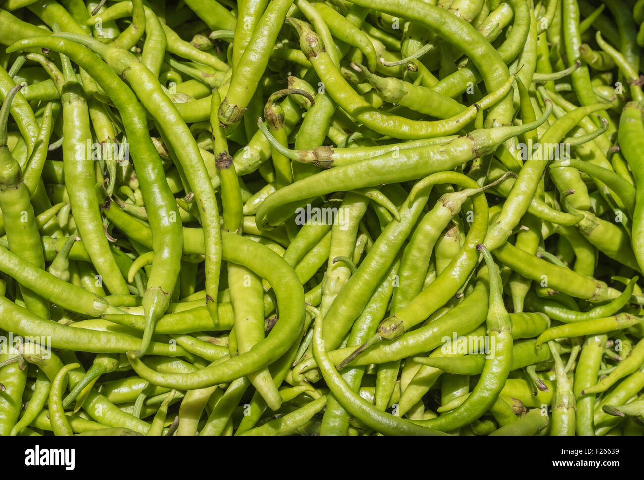 Stack of organic green peppers at the market Stock Photo
