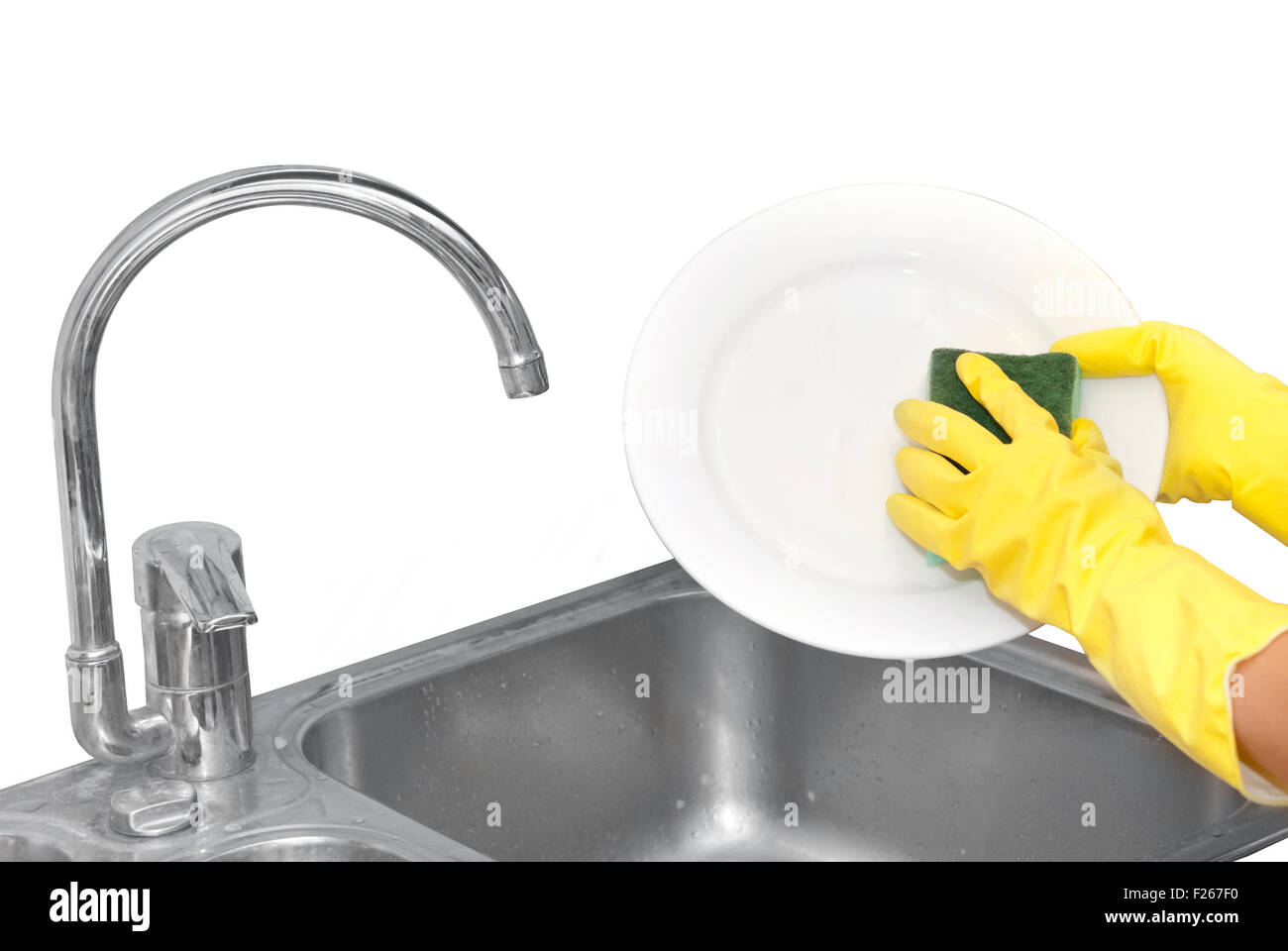 cleaning plate in kitchen Stock Photo Alamy