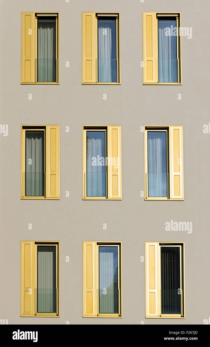 A hotel facade with golden window shutters Stock Photo - Alamy