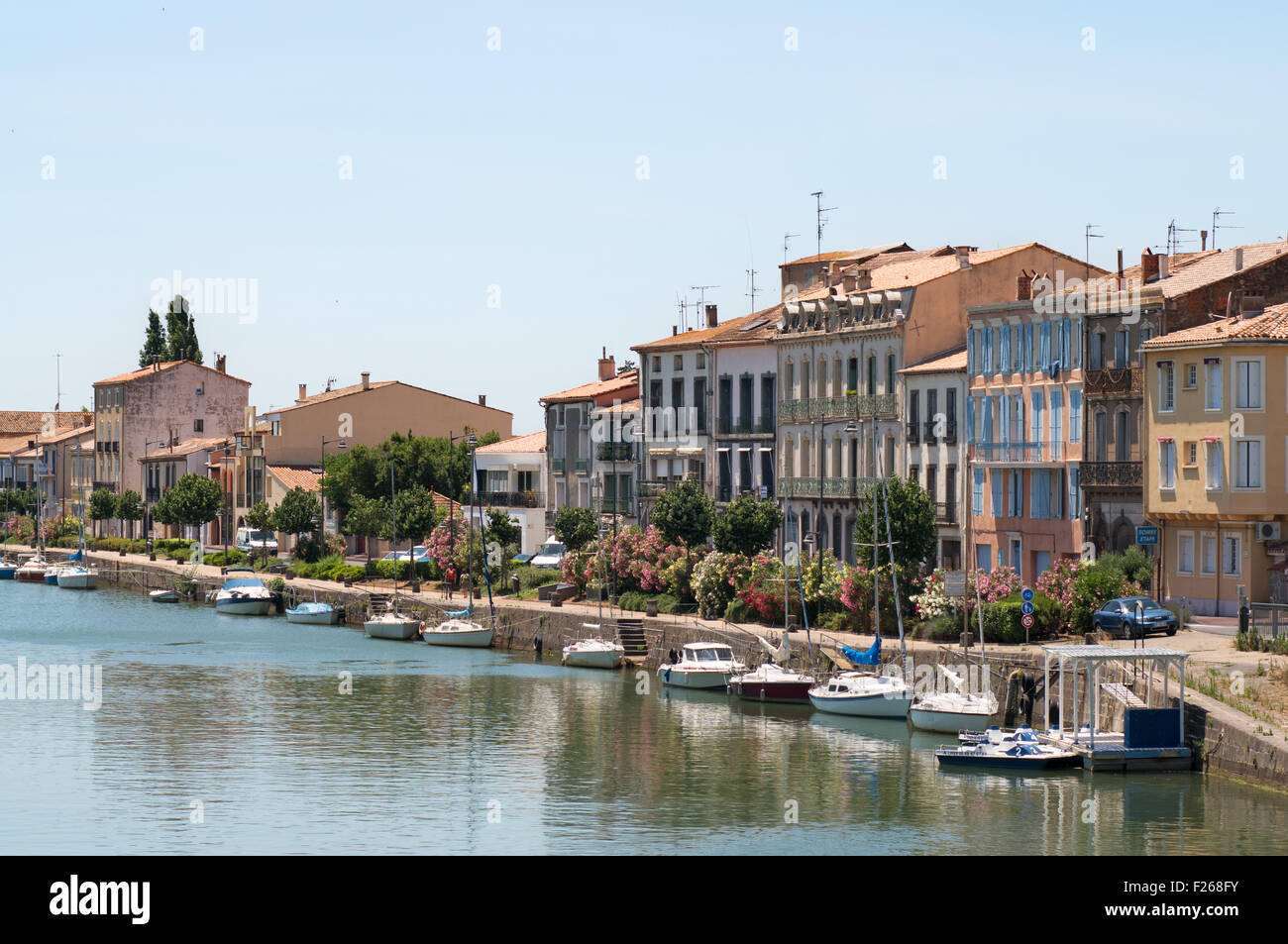Buildings along the quayside of the river Hérault in Agde,  Hérault,  Languedoc-Roussillon, France, Europe Stock Photo