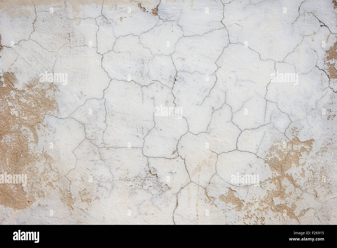 Close-up of a cracked and weathered concrete wall texture background. Stock Photo