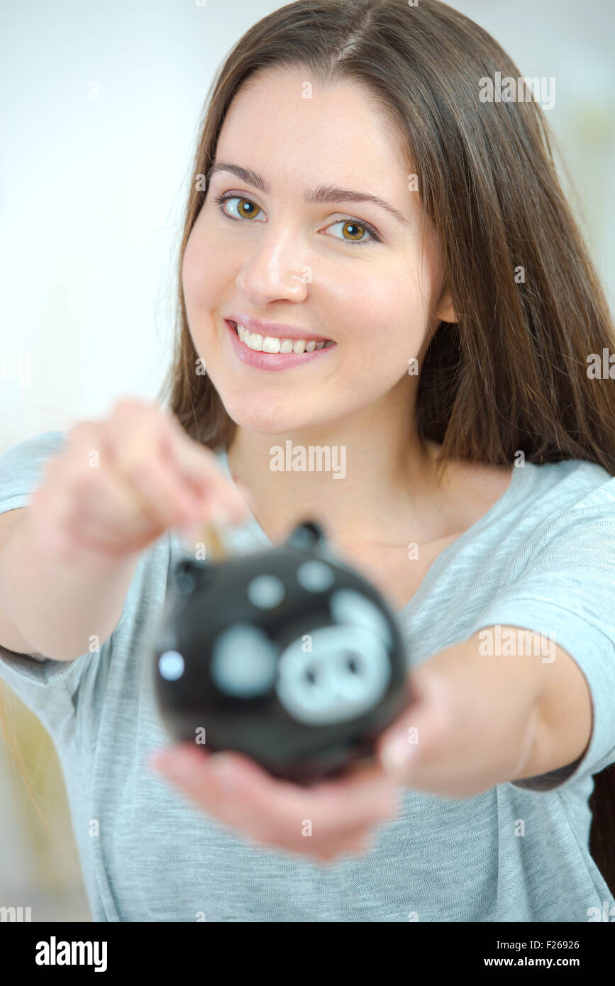 Woman saving for a rainy day Stock Photo