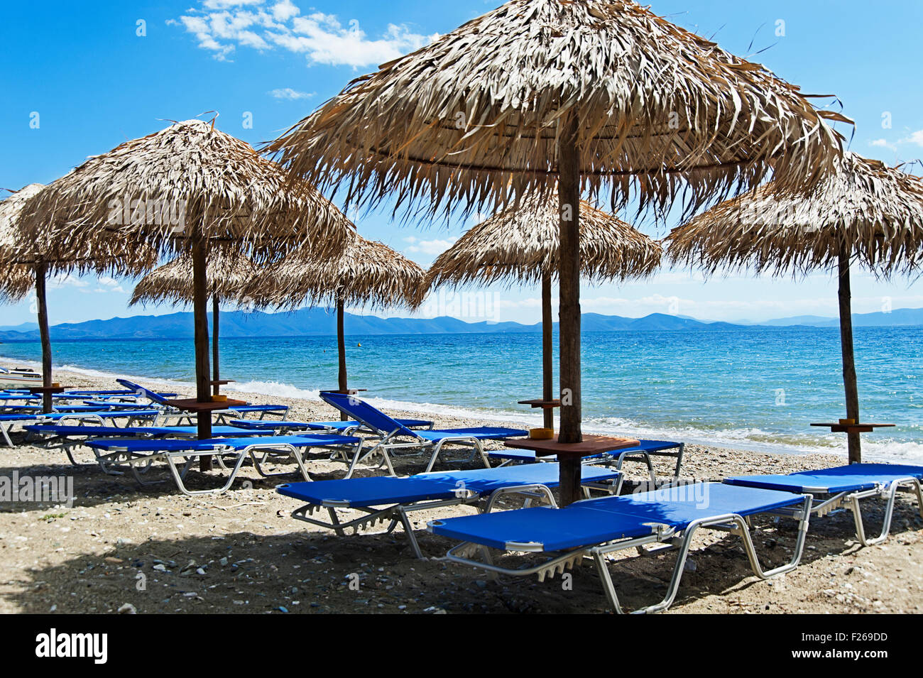 Beach with empty sunbeds and parasols on Pelion Peninsula, Thessaly, Greece Stock Photo