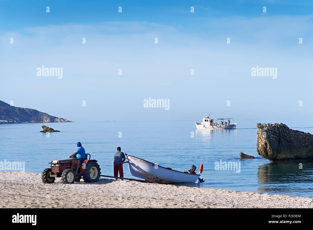 Fishermen launching their boat (Pelion Peninsula, Thessaly, Greece) Stock Photo