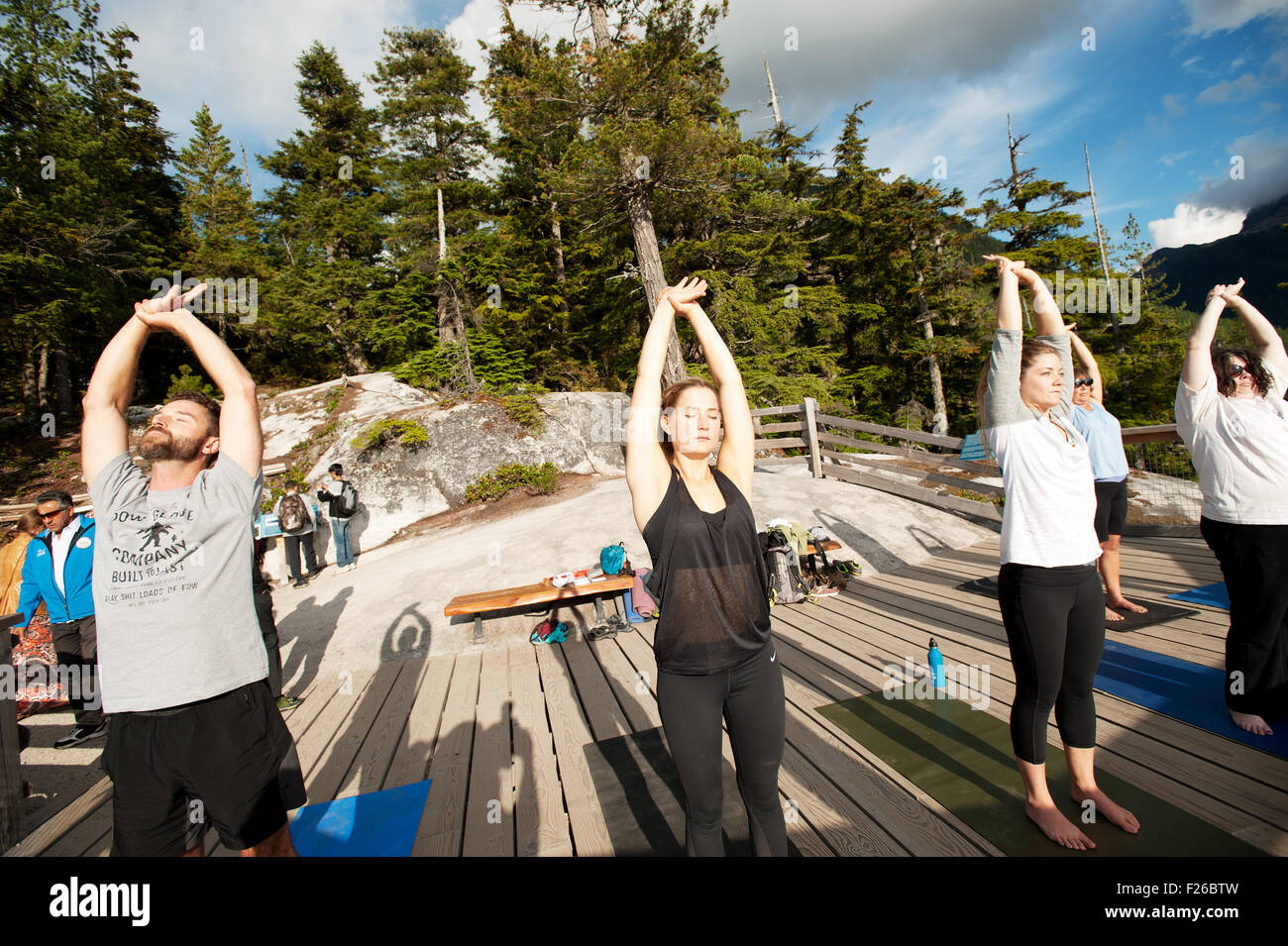 Yoga instructor Annie Martinello, from the Squamish Yoga Studio Co-Op, leads a class at the top of the Sea to Sky Gondola. Stock Photo