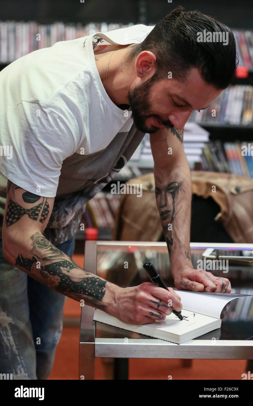 Turin, Italy. 12th Sep, 2015. The Italian rapper and songwriter Francesco Tarducci, also known as 'Nesli', signs autograph of his first novel titled 'Andrà tutto bene'. at Mondadori bookshop. © Elena Aquila/Pacific Press/Alamy Live News Stock Photo