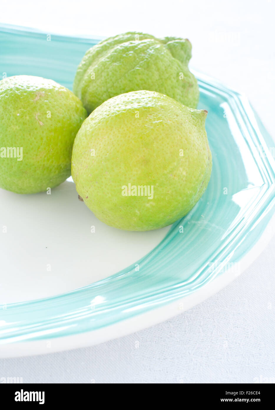 group of green lemons on colored background Stock Photo