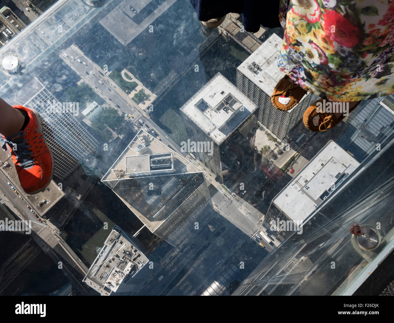 Tourists enjoying the aerial view of Chicago from Willis Tower Skyview Ledge Stock Photo