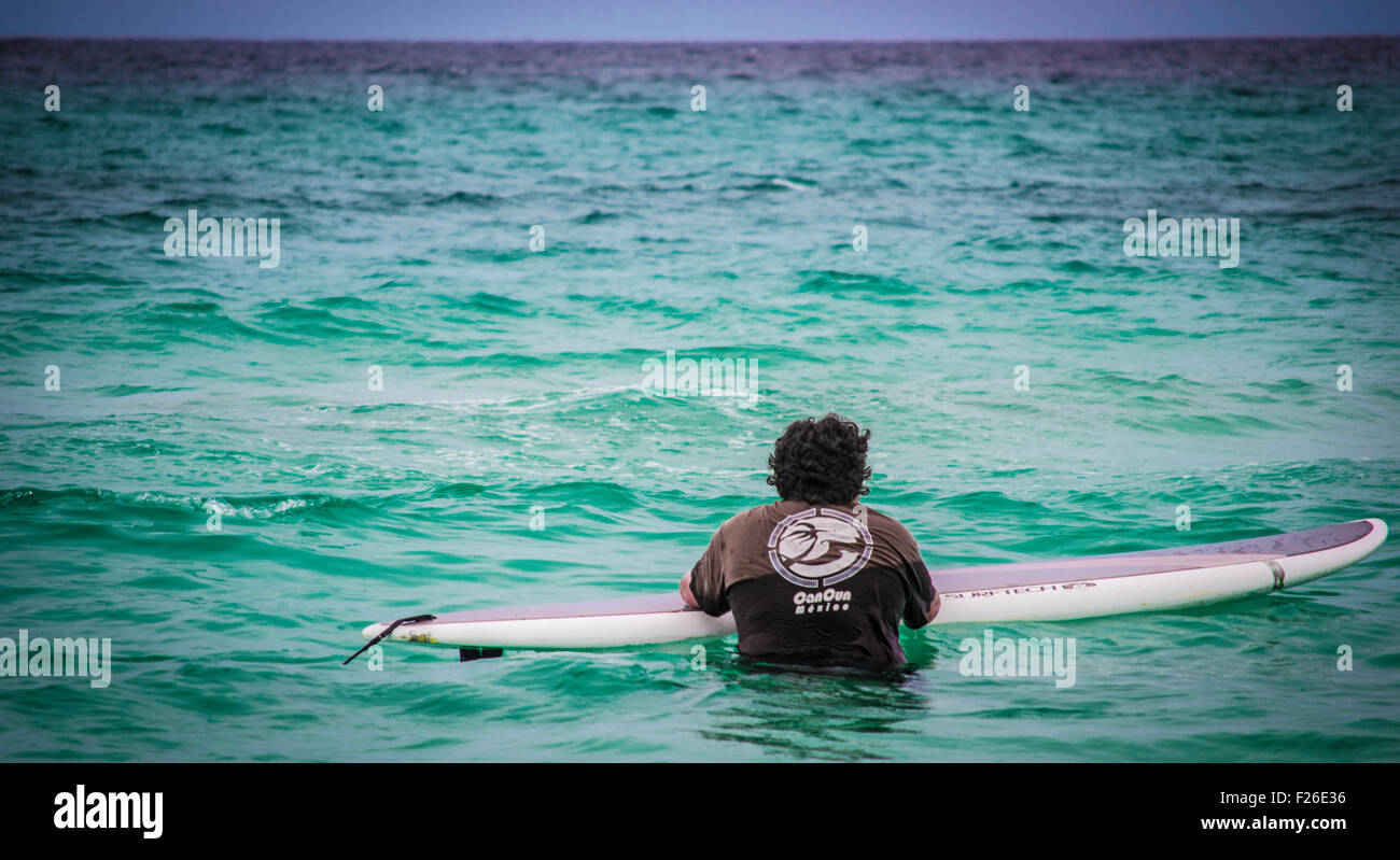 Surfing on a paddle board in Cancun Mexico Stock Photo