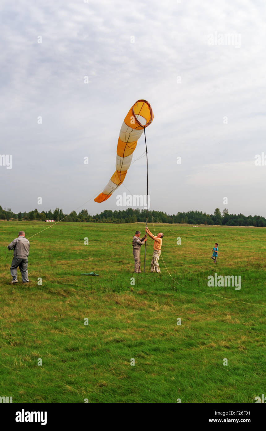 Parachutists - 2014. Assembling of a cone from fabric on a mast - wind direction indicator. Stock Photo