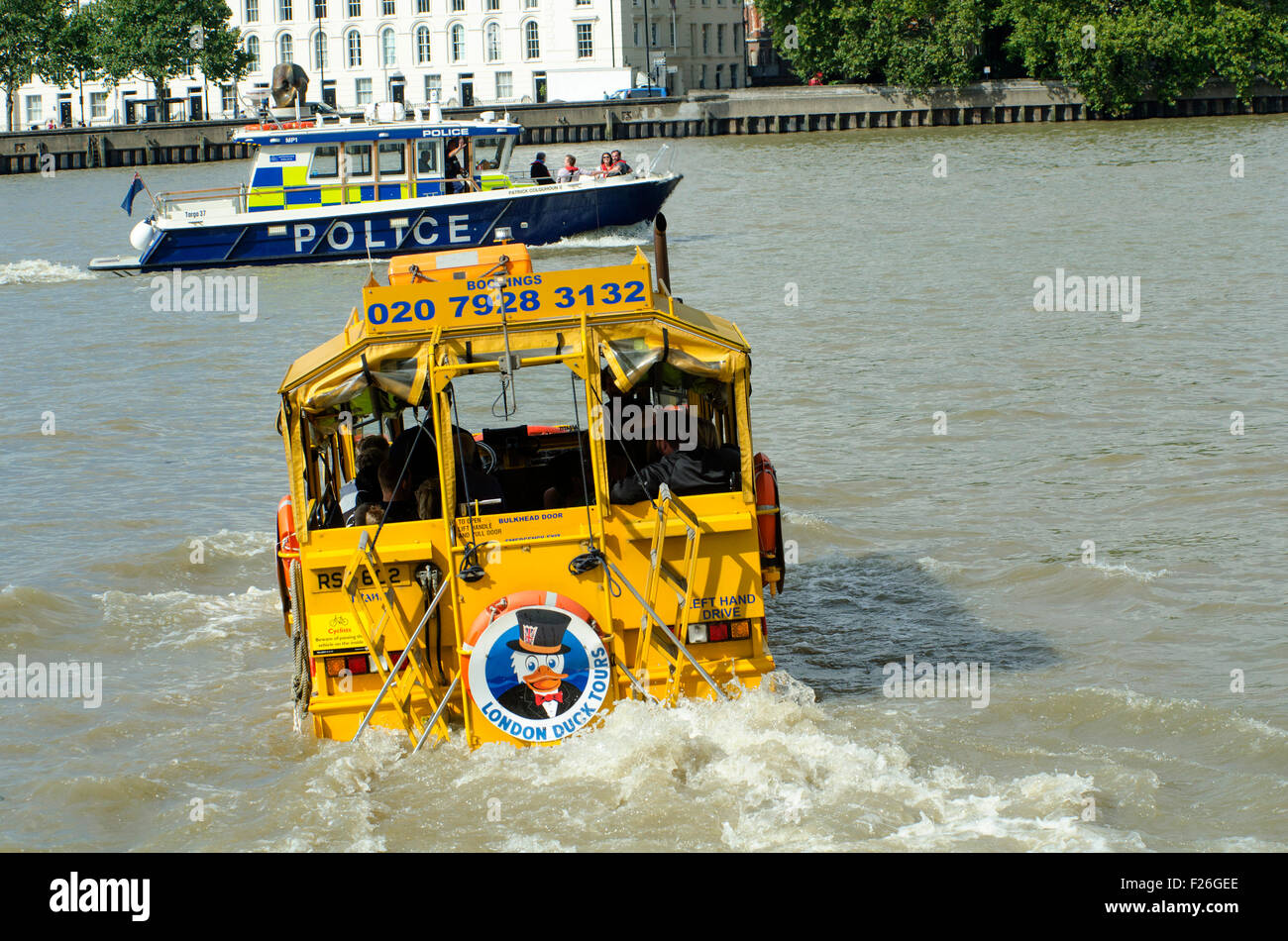 London,UK,11/09/2015 London Duck Tours at work carrying tourists on sunny day on Thames.DUKW,or Duck,is six-wheel-drive amphibious truck first made US mid-1940s.21,000 were produced for use during World War Two to move men materials ashore.Serving also on D-Day Normandy landings,where 40% supplies landed on beaches were carried by DUKWs.They remained service with British other armies into 1970s. Stock Photo