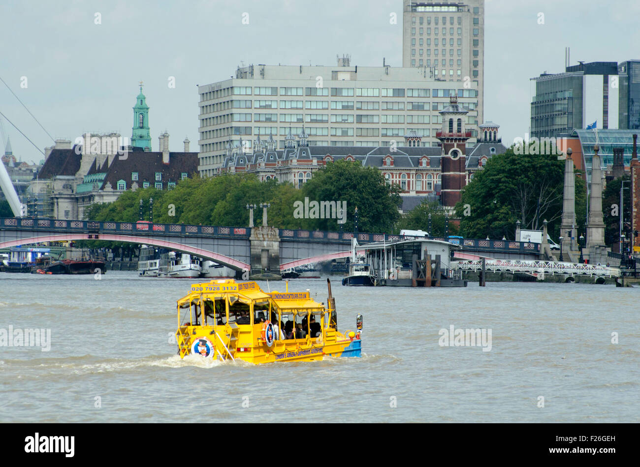 London,UK,11/09/2015 London Duck Tours at work carrying tourists on sunny day on Thames.DUKW,or Duck,is six-wheel-drive amphibious truck first made US mid-1940s.21,000 were produced for use during World War Two to move men materials ashore.Serving also on D-Day Normandy landings,where 40% supplies landed on beaches were carried by DUKWs.They remained service with British other armies into 1970s. Stock Photo