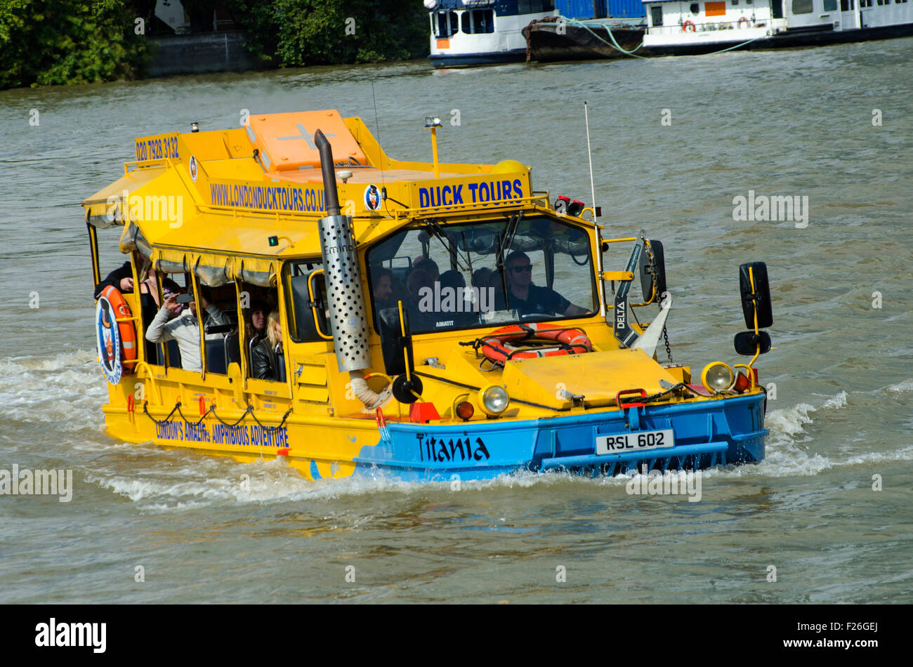 London,UK,11/09/2015 London Duck Tours at work carrying tourists on sunny day on Thames.DUKW,or Duck,is six-wheel-drive amphibious truck first made US mid-1940s.21,000 were produced for use during World War Two to move men materials ashore.Serving also on D-Day Normandy landings,where 40% supplies landed on beaches were carried by DUKWs.They remained service with British other armies into 1970s. Stock Photo