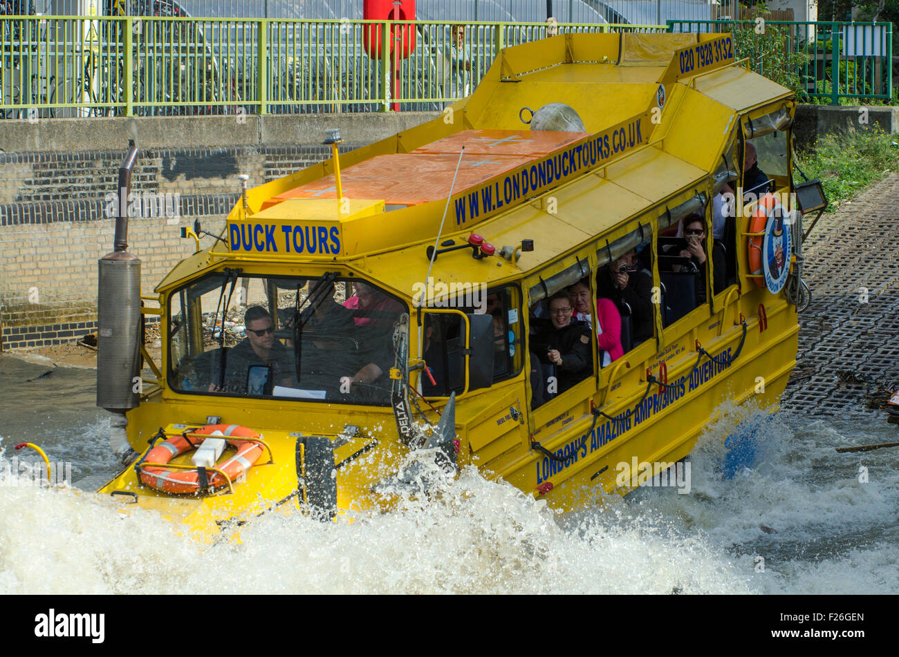 London,UK,11/09/2015 London Duck Tours at work carrying tourists on sunny day on Thames.DUKW,or Duck,is six-wheel-drive amphibious truck first made US mid-1940s.21,000 were produced for use during World War Two to move men materials ashore.Serving also on D-Day Normandy landings,where 40% supplies landed on beaches were carried by DUKWs.They remained service with British other armies into 1970s. Stock Photo