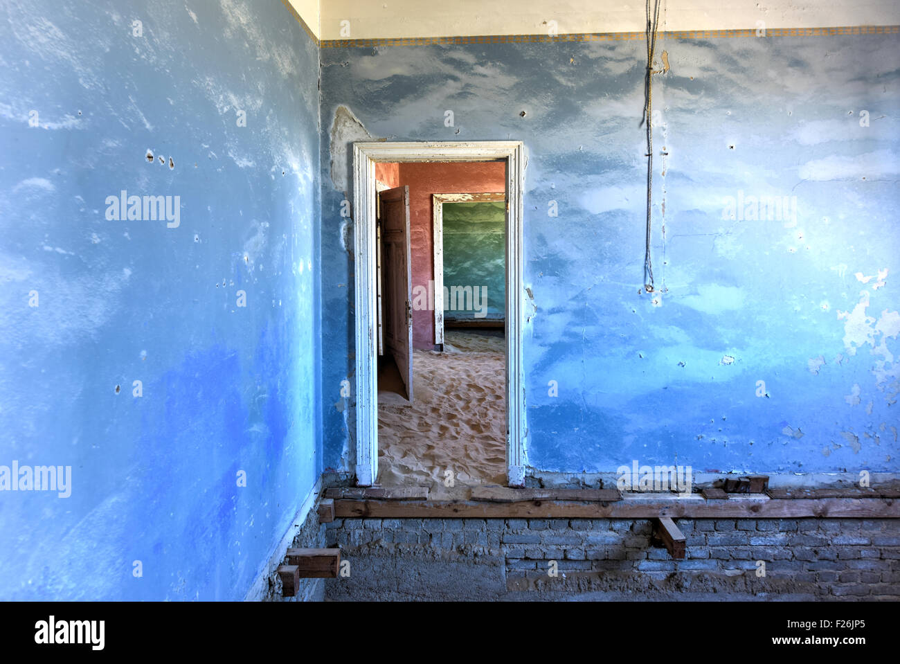 The abandoned ghost diamond town of Kolmanskop in Namibia, which is slowly being swallowed by the desert. Stock Photo
