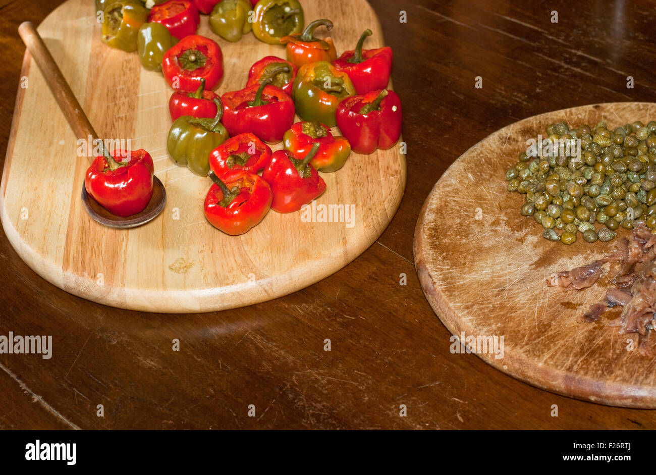 Red hot chili peppers on cutting board, capers and anchovies Stock ...