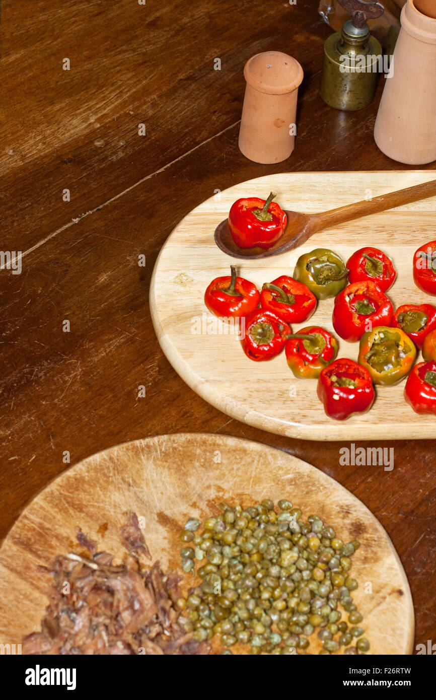 Red hot chili peppers on cutting board, capers and anchovies Stock ...
