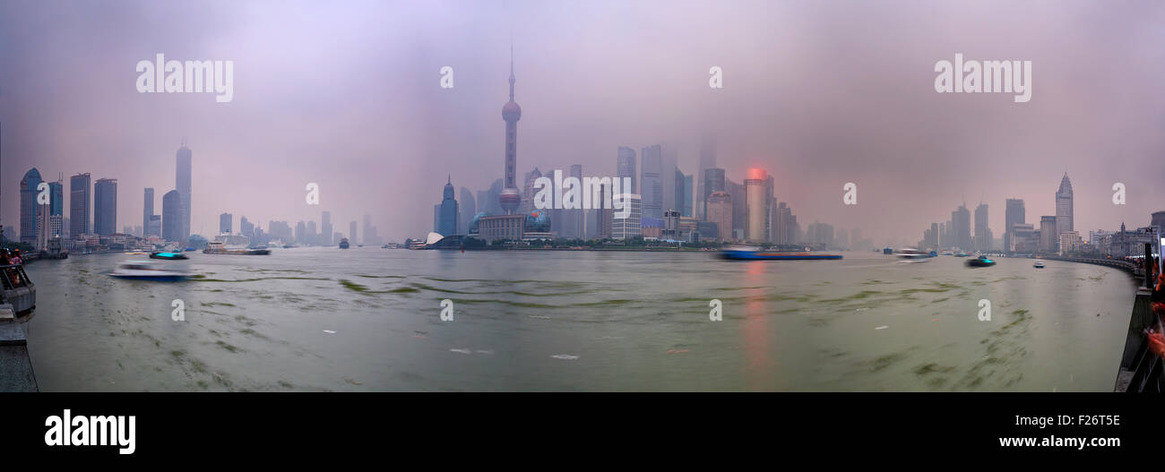 Panoramic view from the Bund towards Pudong in Shanghai at sunset with strong pollution and smog Stock Photo