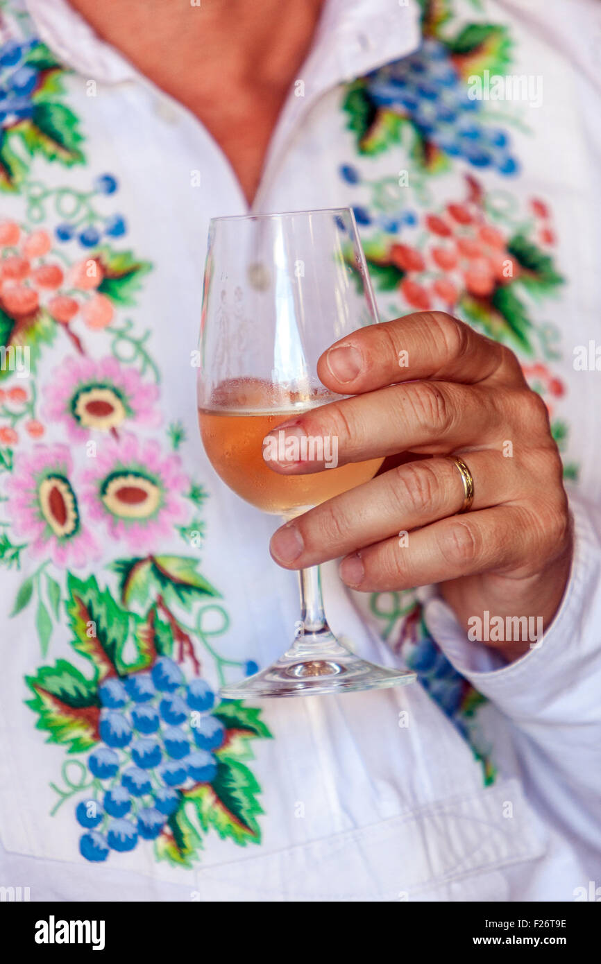 Folk costumes and a glass of white wine, Velke Pavlovice, South Moravia, Czech Republic, Europe Stock Photo