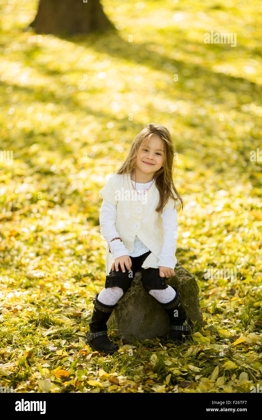 Little girl at the autumn park Stock Photo - Alamy