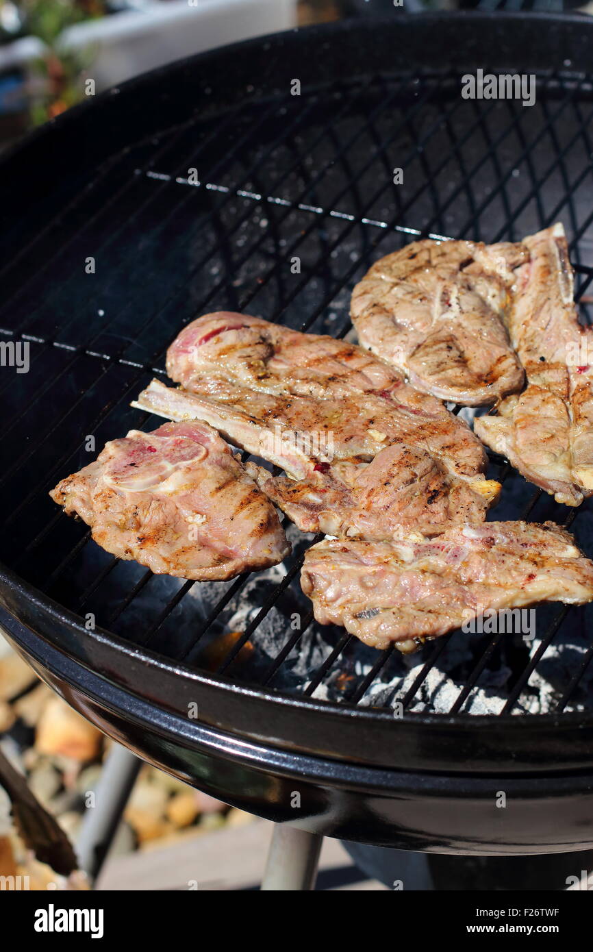 Cooking marinated lamb chops on a barbecue Stock Photo Alamy