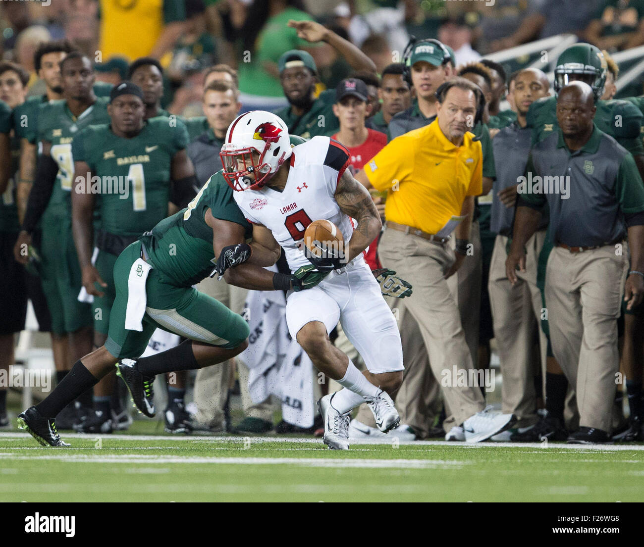 Waco, TX, USA. 12th Sep, 2015. Lamar Cardinals wide receiver Reggie Begelton  #9 is tackled near the Balyor Bears sideline during the NCAA football game  between the Lamar Cardinals and the Baylor