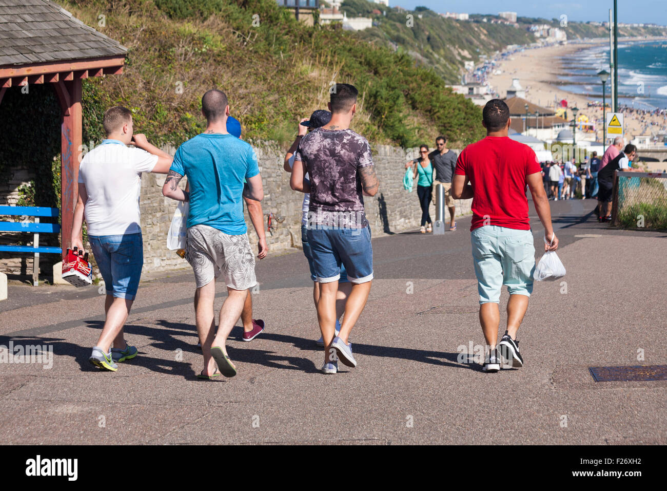 Group of lads in Bournemouth heading for the beach, a popular destination for stag nights/weekends, in September Stock Photo