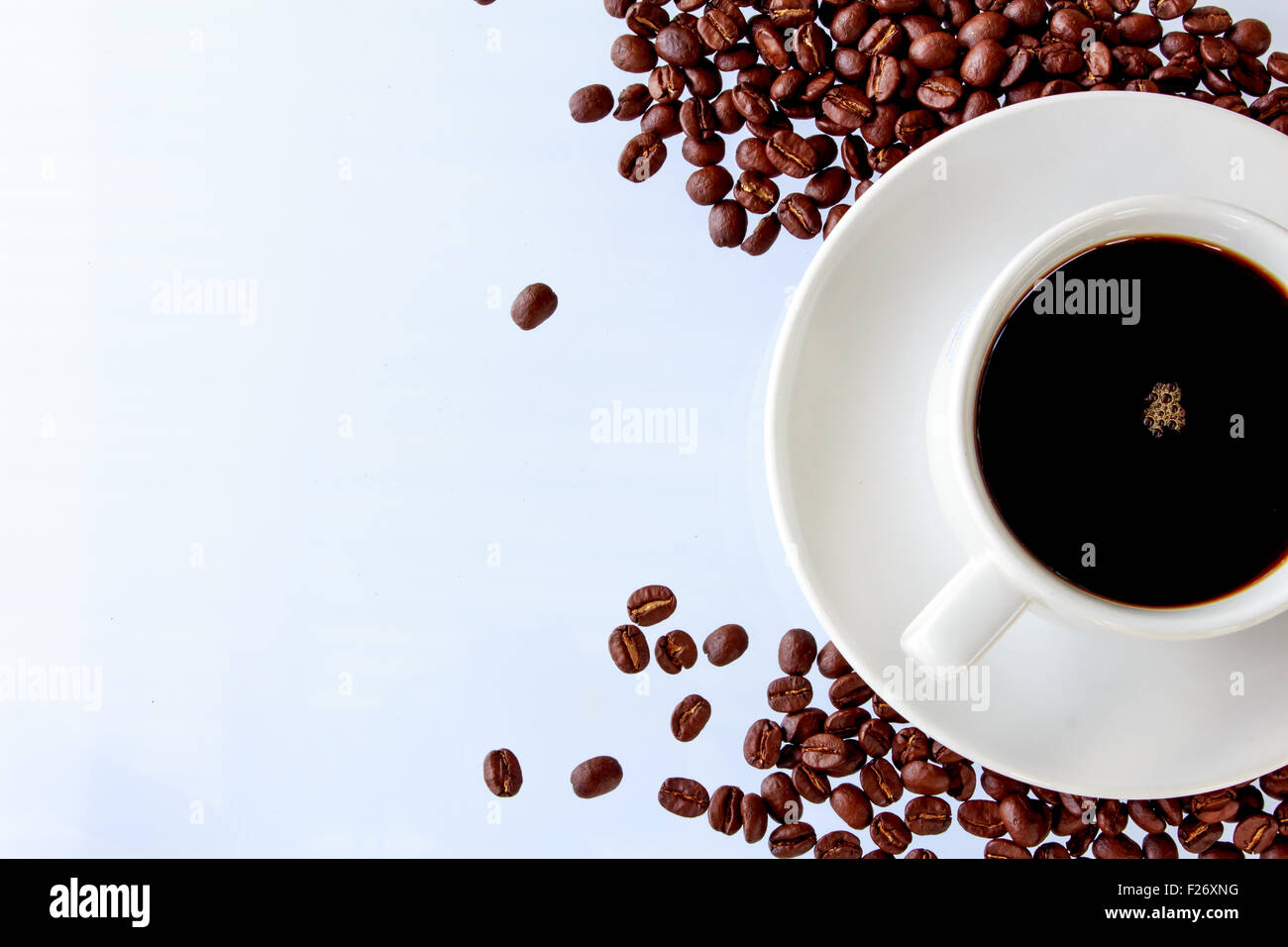 Coffee cup and coffee beans on a white background Stock Photo - Alamy