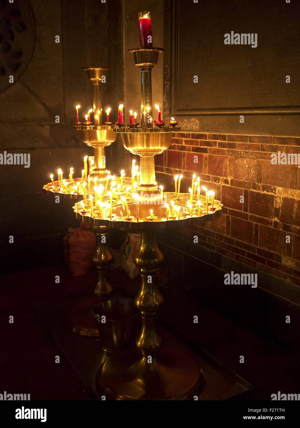 Group of burning religious candles on candlestick in bao an temple