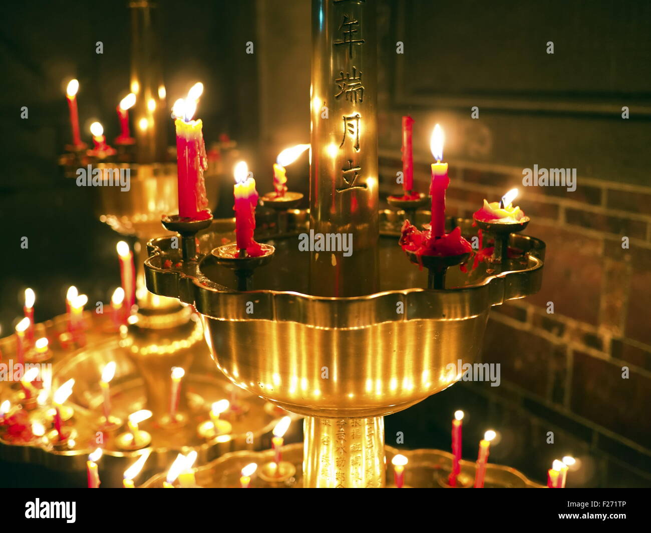 Group of burning religious candles on candlestick in bao an temple