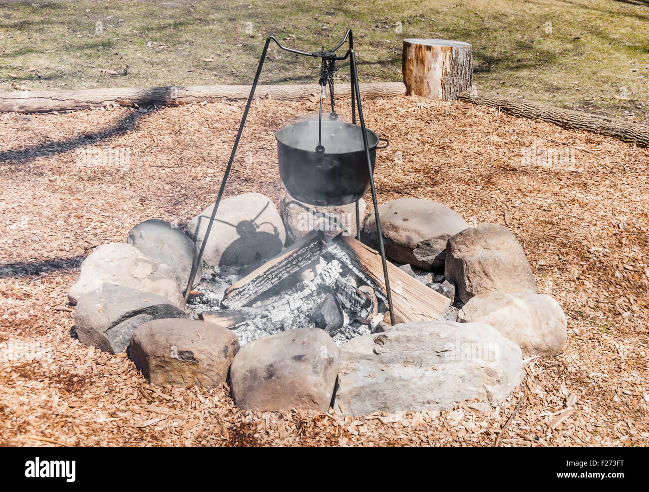 outdoor cooking scene with Cauldron on Campfire Stock Photo