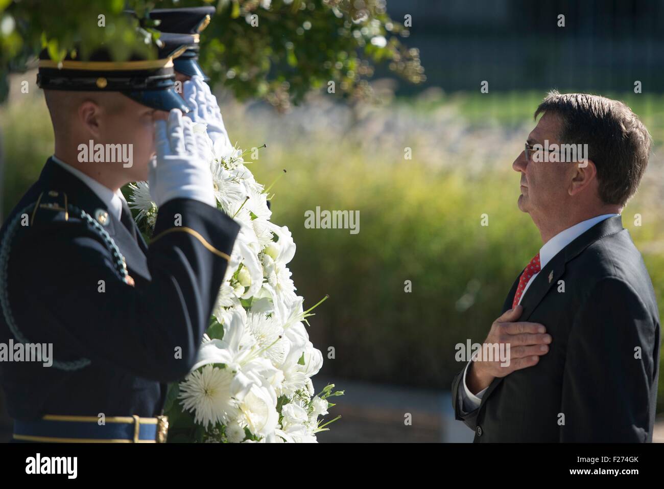 U.S. Defense Secretary Ash Carter places a wreath during a ceremony to remember the victims of the 9/11 terror attacks at the Pentagon Memorial on the anniversary of the attacks September 11, 2015 in Arlington, Virginia. Stock Photo