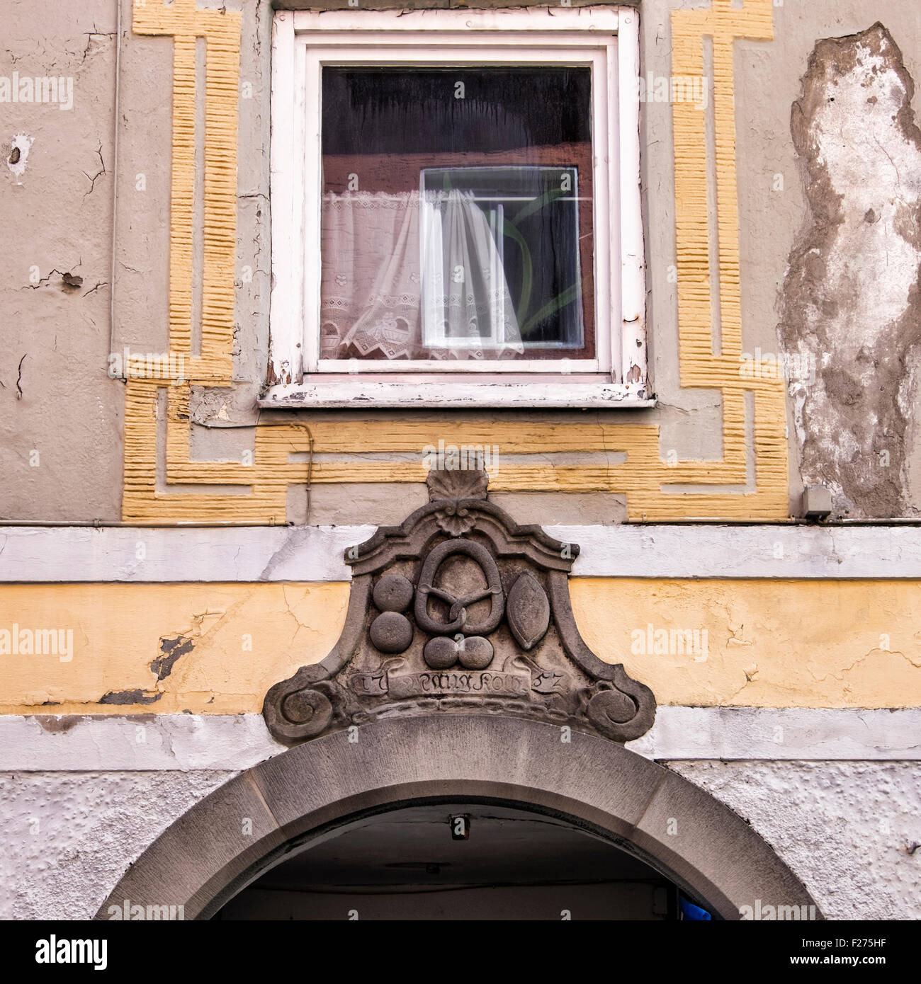 Building detail, Stone crest over door & house needing repair, Füssen Town, Ostallgaü, Bavaria, Germany Stock Photo