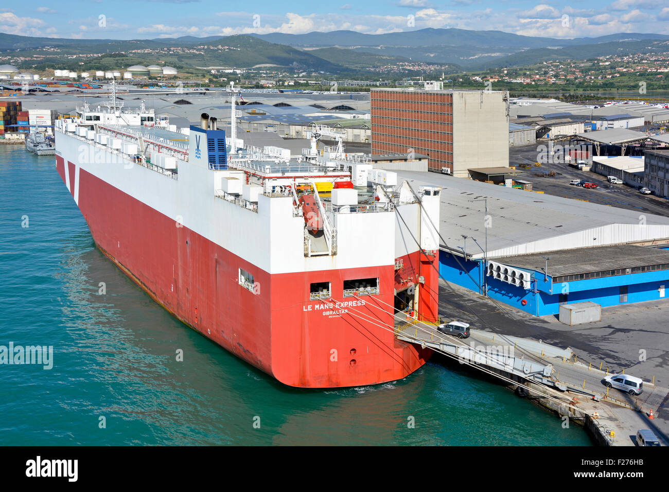 Port of Koper Slovenia urban landscape new cars being driven onto dedicated vehicle carrier Le Mans Express shipping cars abroad Stock Photo