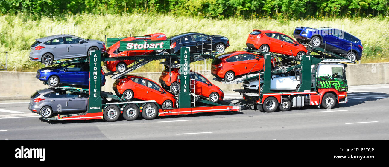 Car transporter supply chain transport business Eddie Stobart hgv truck lorry & trailer loaded with eleven new Ford cars on motorway Essex England UK Stock Photo