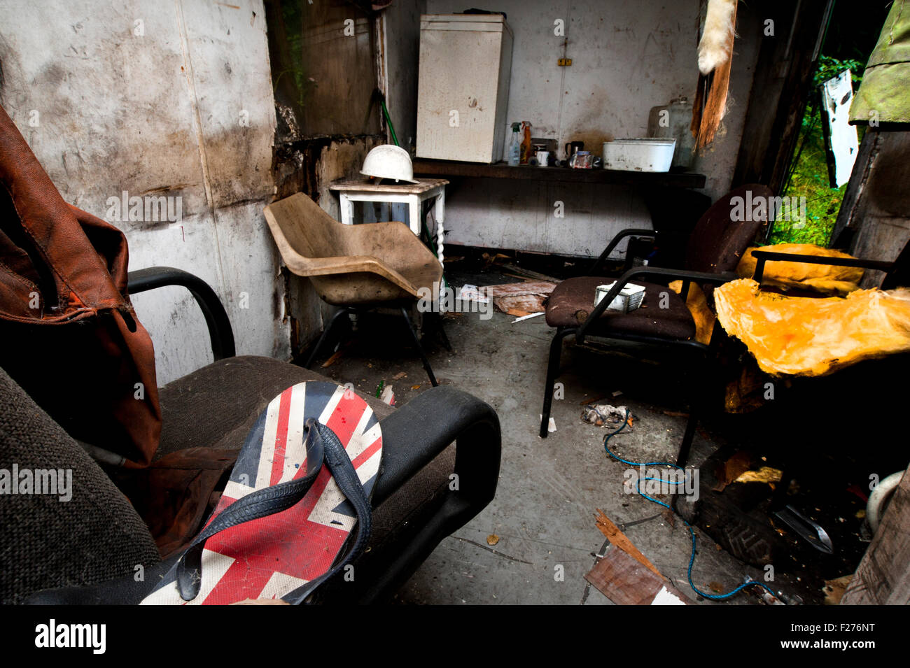 Swansea, UK. 12th Sep, 2015. The work hut, now in a state of decay, holds the personal belongings of 4 miners killed in the Gleision mine disaster in 2011. A union jack flipflop is placed on the chair, probably a prank played on one of the miners, before they returned back after their shift, to shower. They never returned. Credit:  roger tiley/Alamy Live News Stock Photo