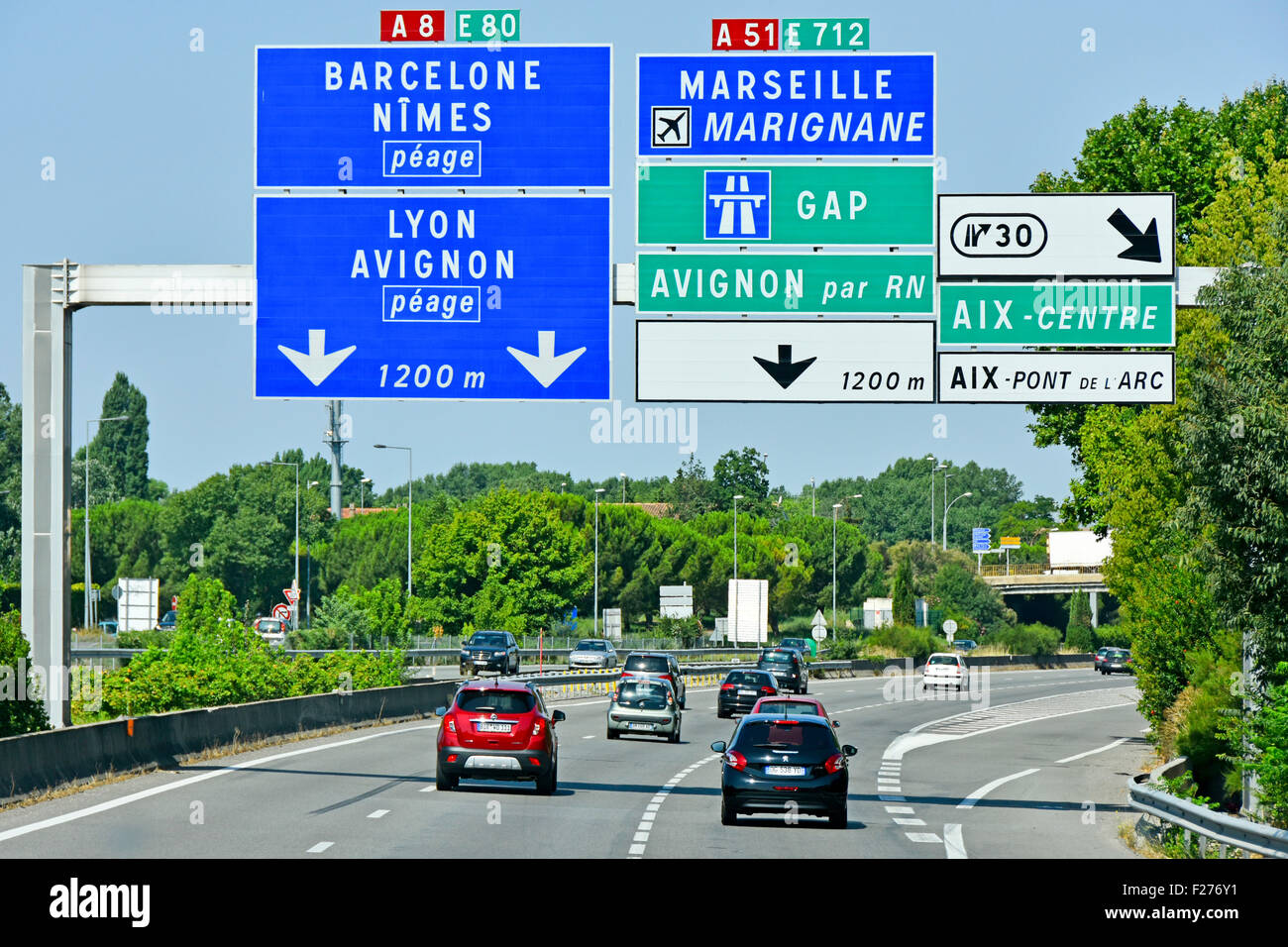 French toll AutoRoute motorway in Provence France gantry signs above A8 showing connecting routes and junctions light car traffic summer Stock Photo