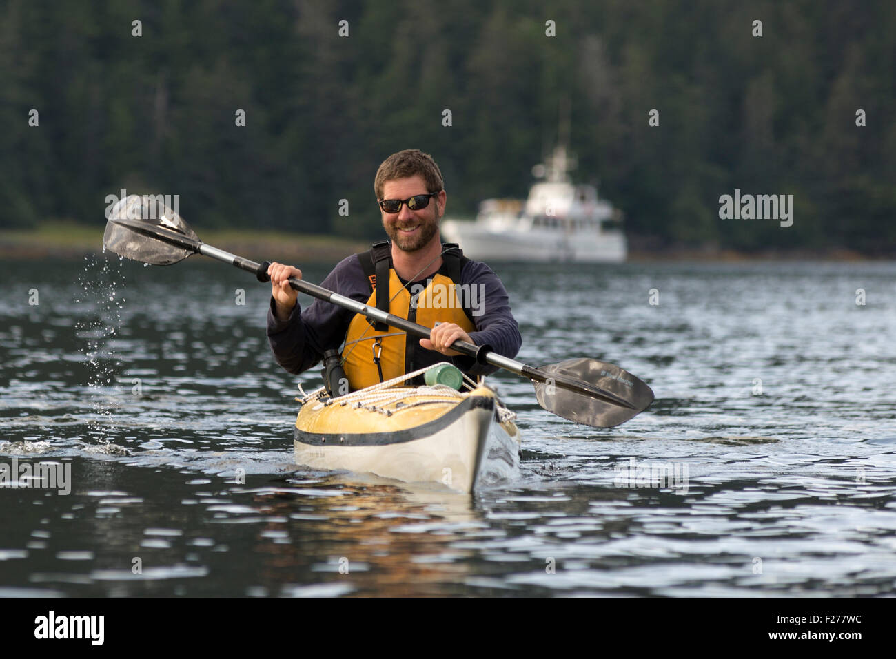 Sea kayaking from a mothership on a small boat cruise in Southeast Alaska. Stock Photo