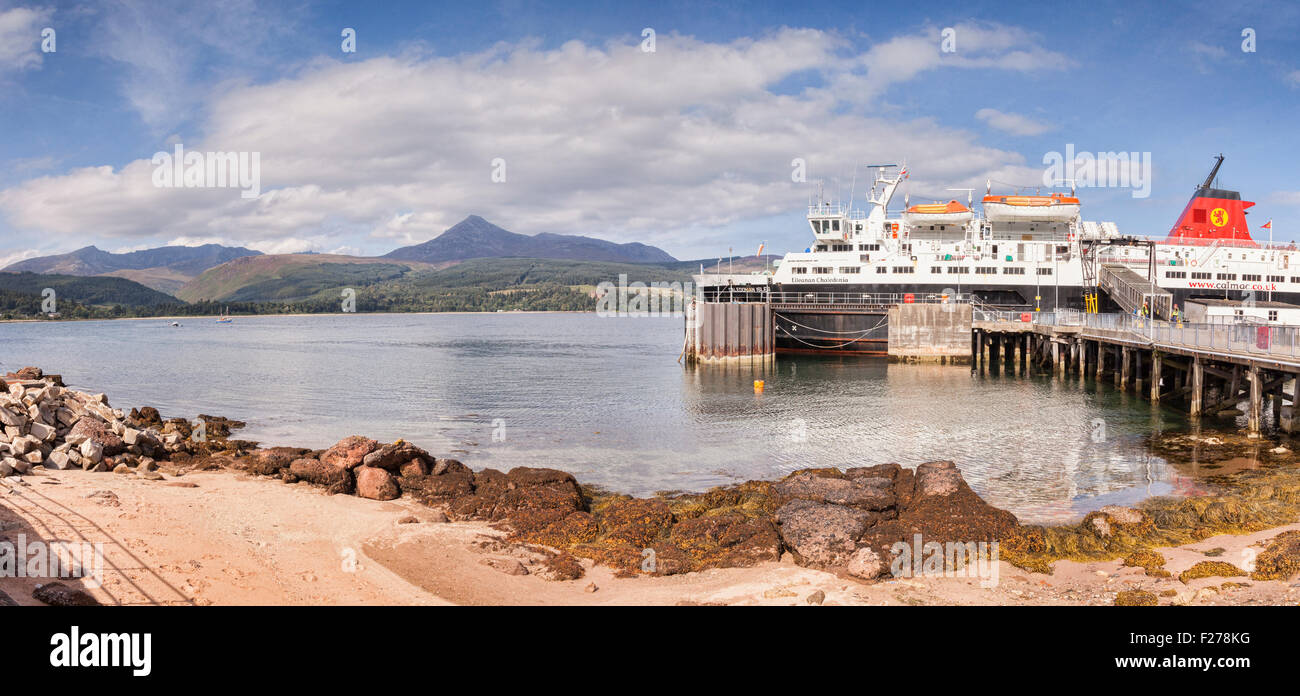 Calmac ferry 'Caledonian Isles' moored at Brodick Harbour on the island of Arran, Scotland, with Goat Fell, the island's highest Stock Photo