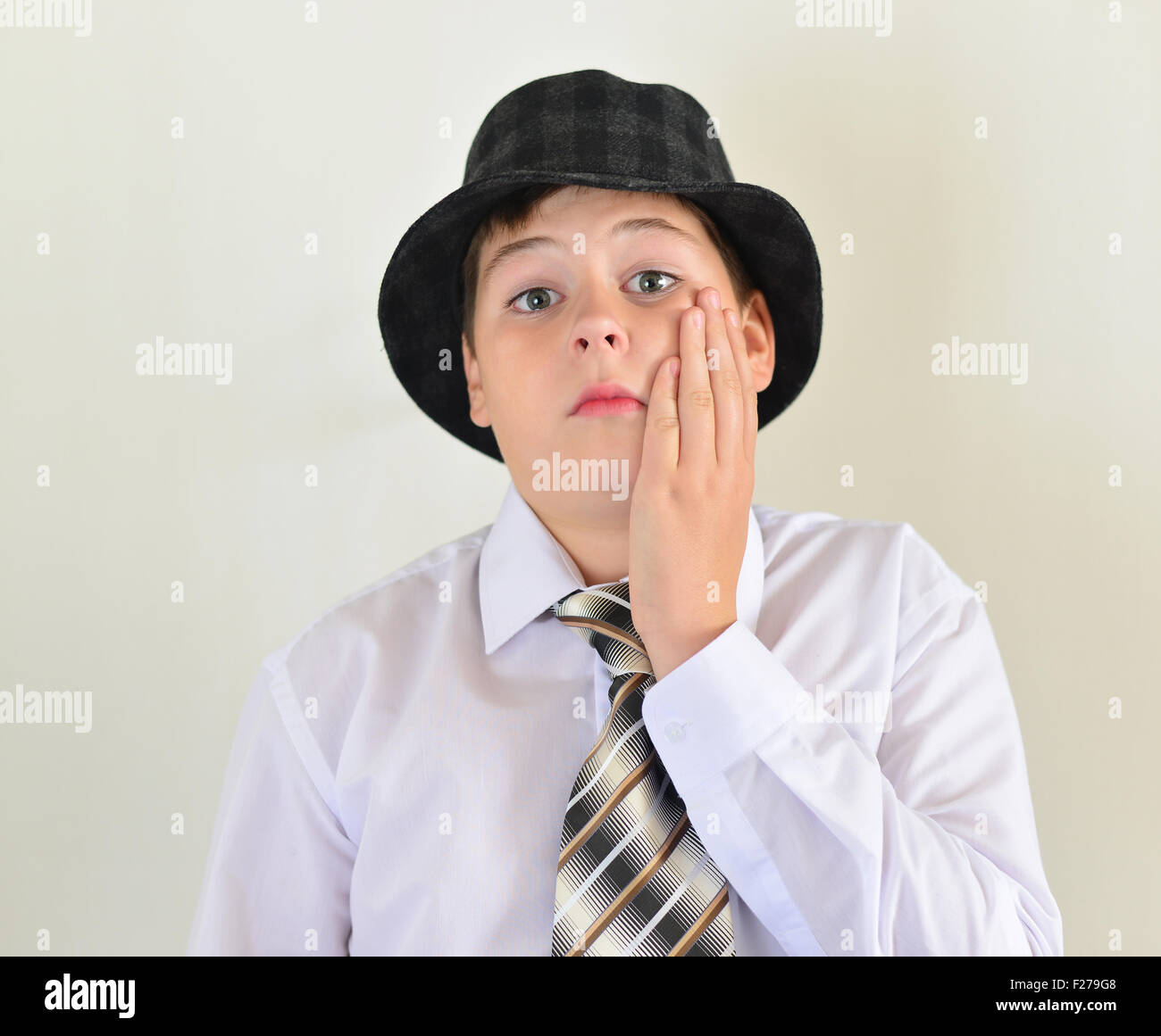 portrait of a teenage boy in a hat and tie Stock Photo Alamy
