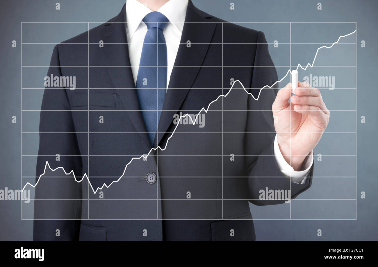 Businessman drawing a growing chart with chalk Stock Photo - Alamy