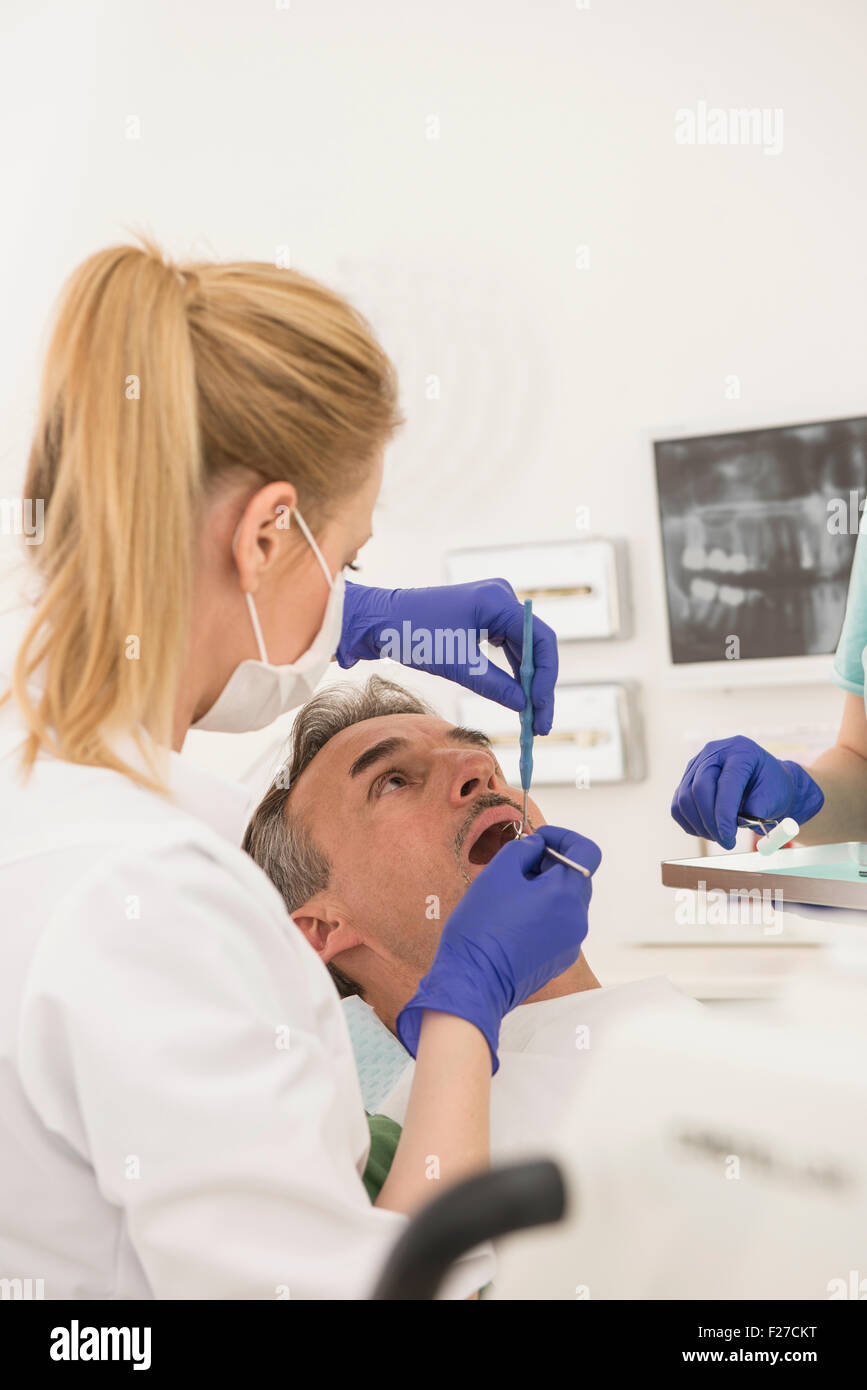 Female dentist examining patient, Munich, Bavaria, Germany Stock Photo