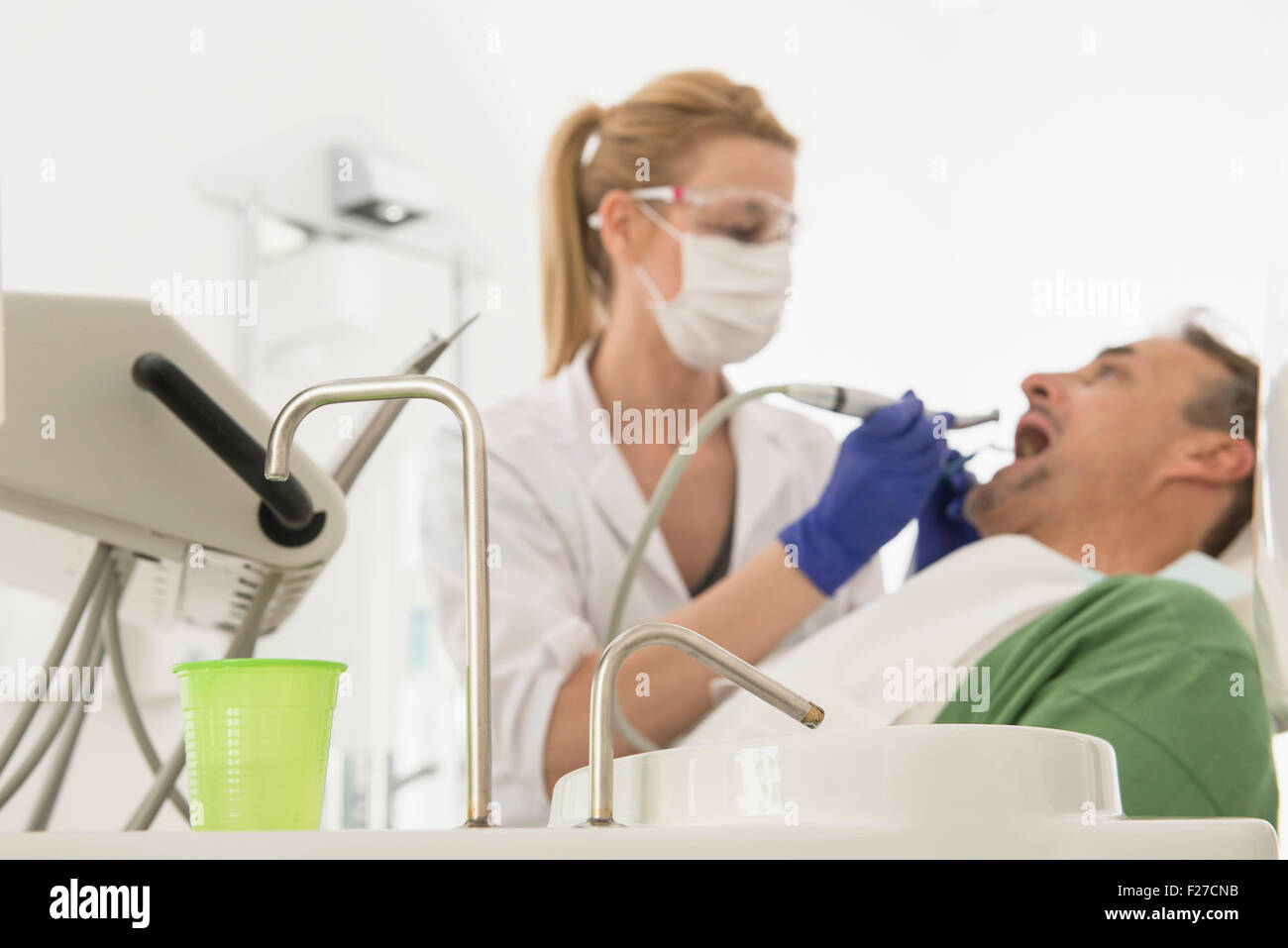 Female dentist examining patient, Munich, Bavaria, Germany Stock Photo