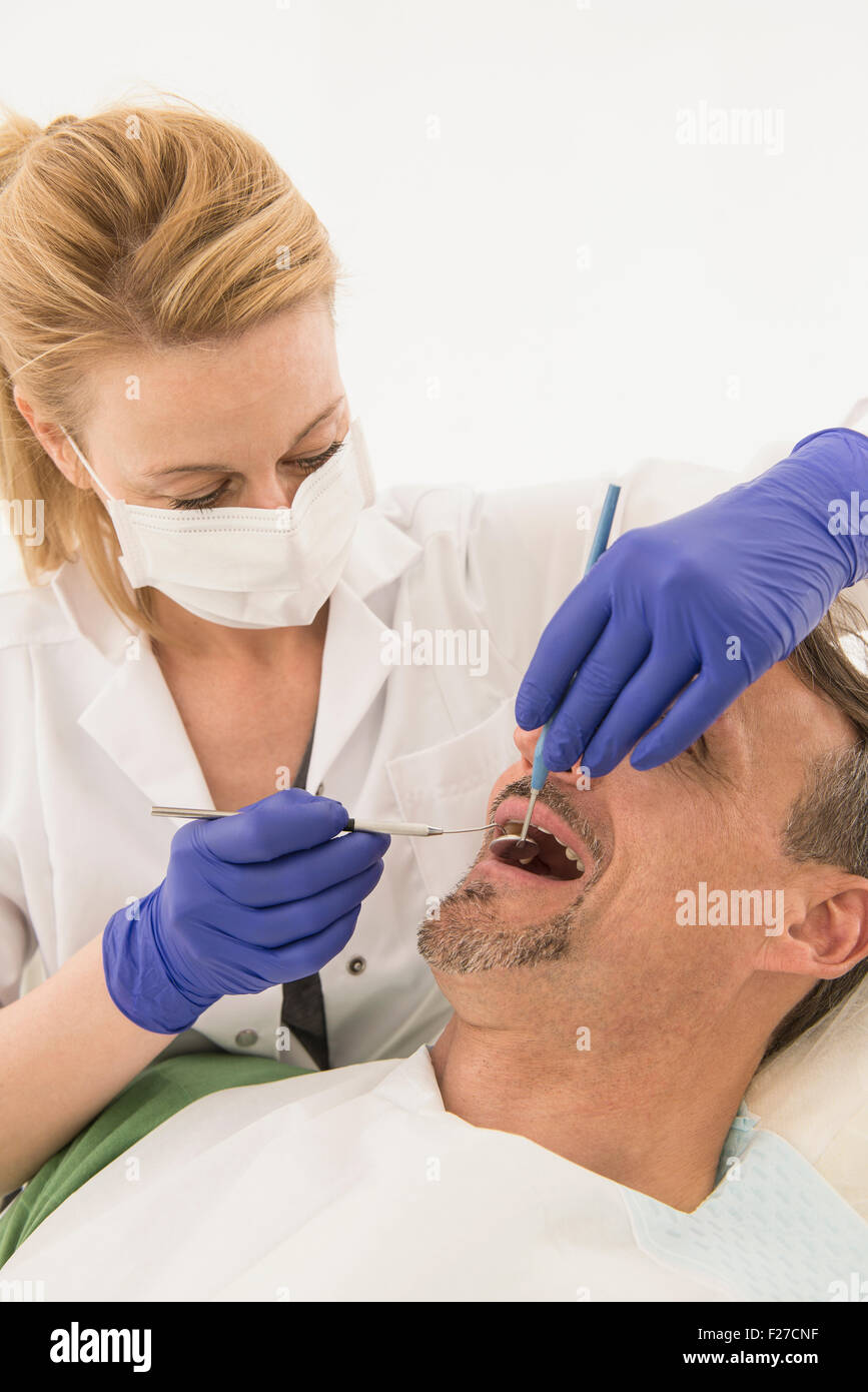 Female dentist examining patient, Munich, Bavaria, Germany Stock Photo