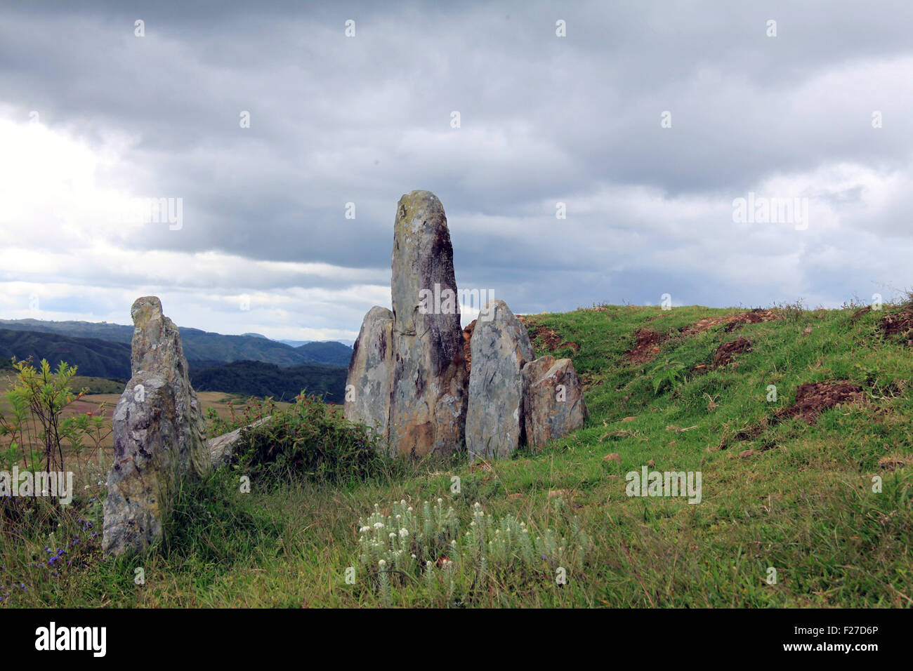 Megaliths on a green hillside in northeastern India Stock Photo
