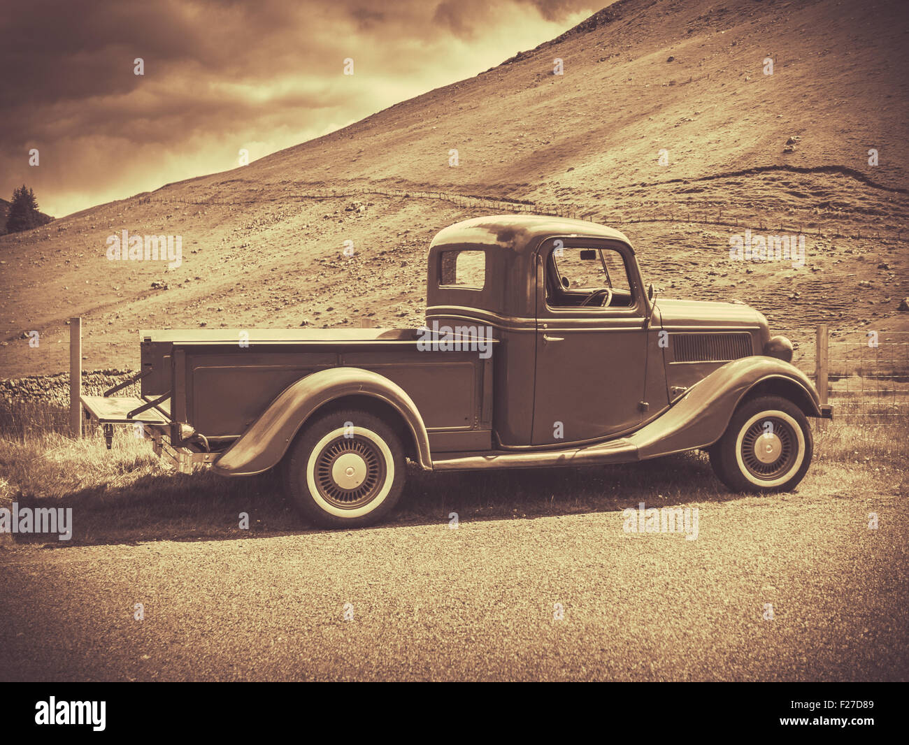 Retro Style Sepia Image Of A Vintage Truck In The Countryside Stock Photo