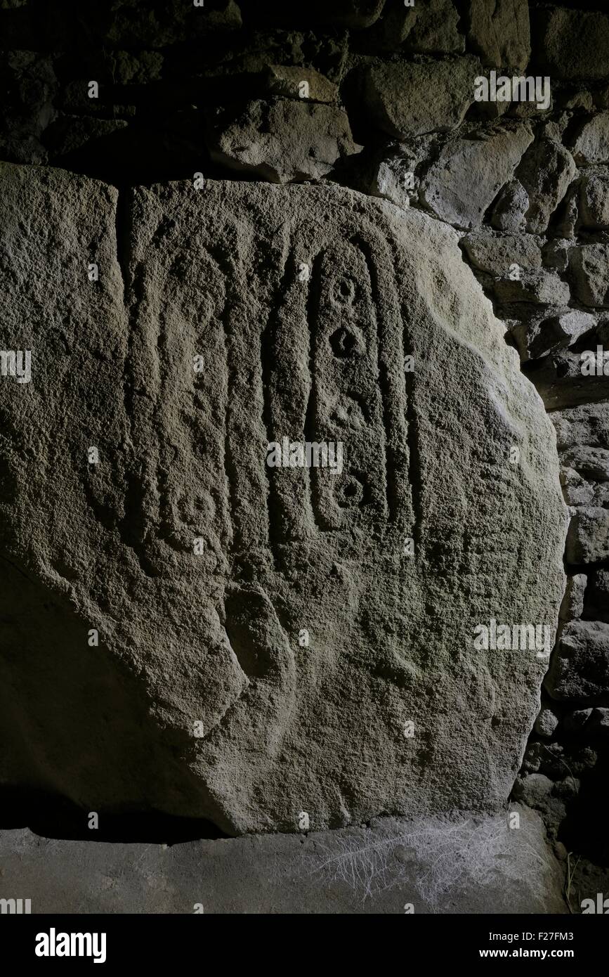 Les Pierres Plates prehistoric Neolithic passage grave. Locmariaquer, Brittany, France. One of the passageway carved stones Stock Photo