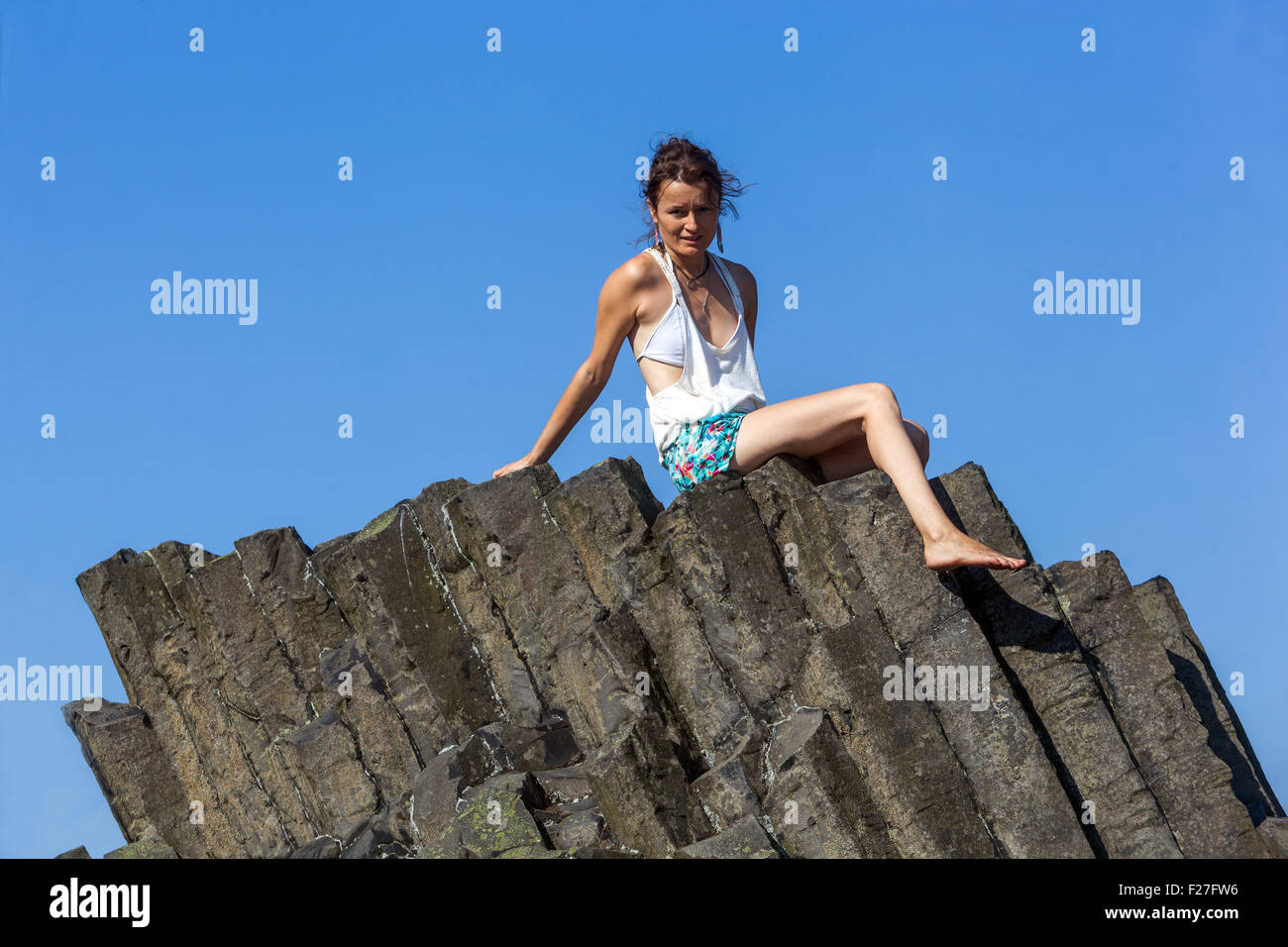 Woman on volcanic rock, Panska Skala, Kamenicky Senov, Northern Bohemia, Czech Republic, Europe Stock Photo