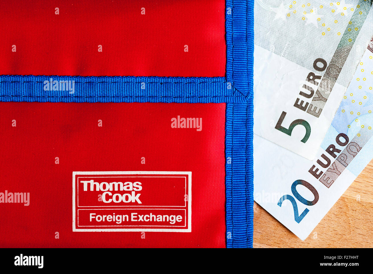 20 euro and 5 euro notes next to a Thomas Cook wallet for holiday money. Stock Photo